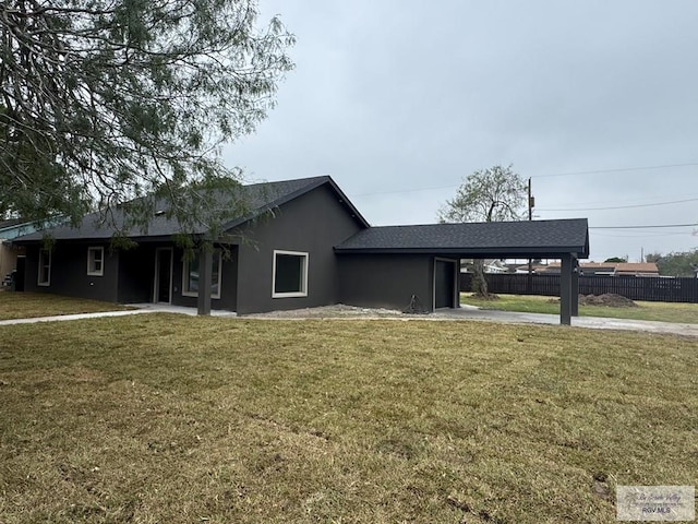 view of front of property with a front yard and a carport