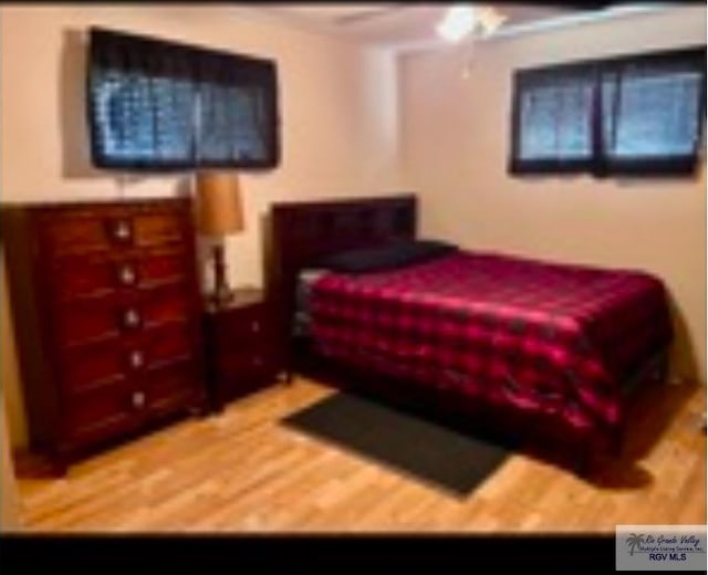 bedroom featuring hardwood / wood-style flooring and ceiling fan