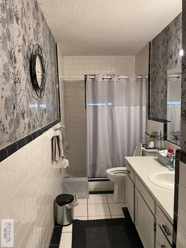 bathroom with tile patterned floors, a shower with curtain, and tile walls