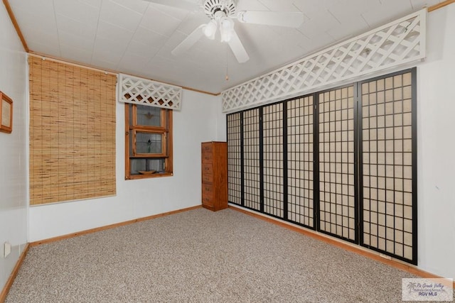 empty room with carpet and ceiling fan