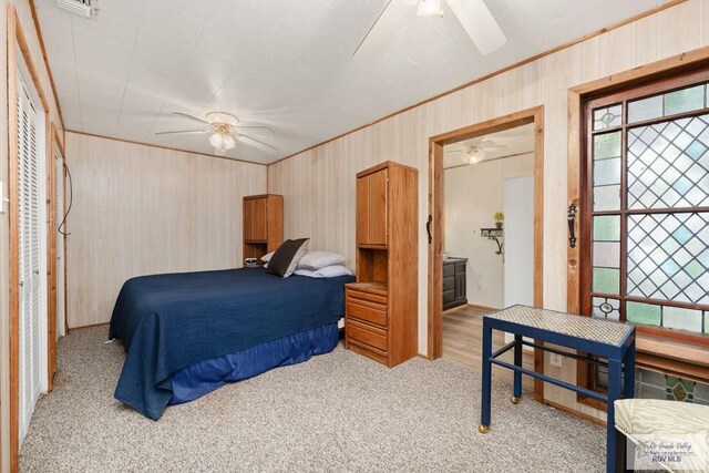 bedroom with connected bathroom, ceiling fan, and light carpet