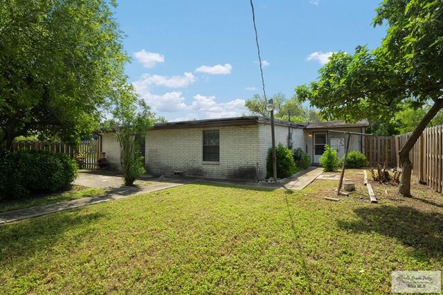 back of house featuring a yard