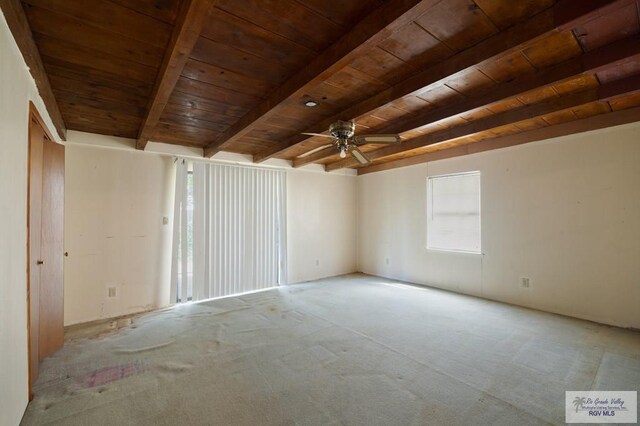 spare room with light carpet, ceiling fan, beamed ceiling, and wood ceiling