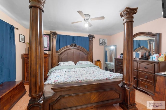 bedroom with ornate columns, light tile patterned floors, and a ceiling fan