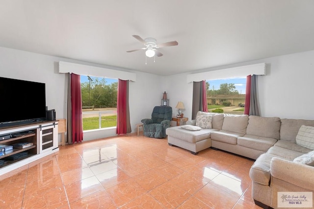 living area featuring light tile patterned floors and ceiling fan