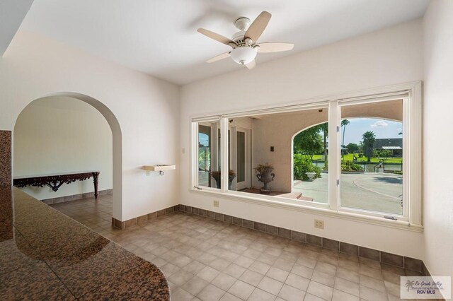 interior space with tile patterned flooring and ceiling fan