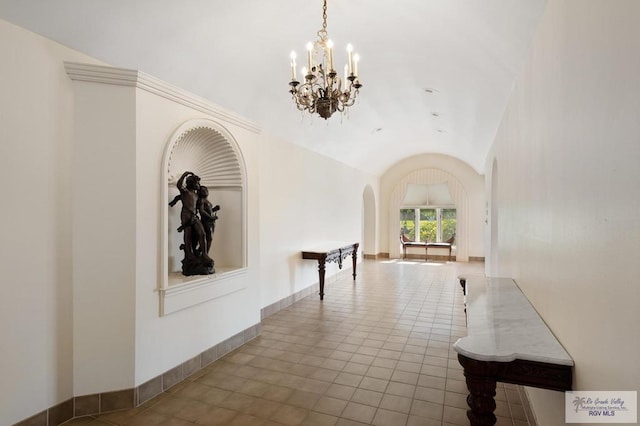1700 Tesoro Ave, Rancho Viejo, TX 78575 - corridor with lofted ceiling, arched walkways, a chandelier, and tile patterned floors