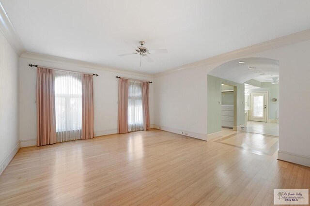 spare room featuring ceiling fan, plenty of natural light, ornamental molding, and light hardwood / wood-style flooring