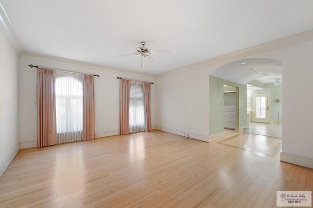 1700 Tesoro Ave, Rancho Viejo, TX 78575 - unfurnished room with a ceiling fan, light wood finished floors, arched walkways, baseboards, and crown molding