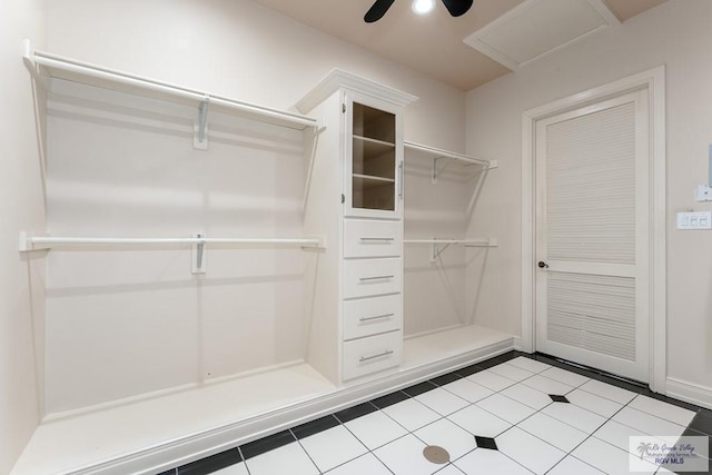 spacious closet featuring light tile patterned floors and ceiling fan