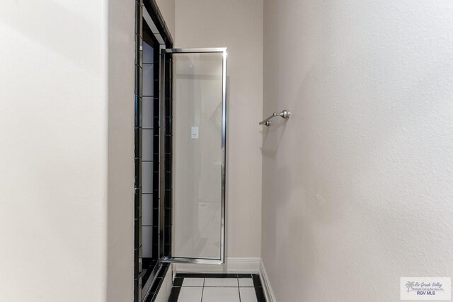 405 E Matz Ave, Harlingen, TX 78550 - bathroom featuring tile patterned floors, baseboards, and an enclosed shower