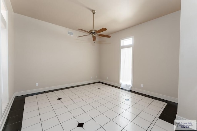 tiled empty room with ceiling fan