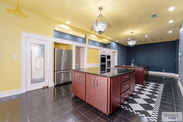 405 E Matz Ave, Harlingen, TX 78550 - kitchen featuring dark tile patterned floors, a center island, dark countertops, stainless steel appliances, and a sink