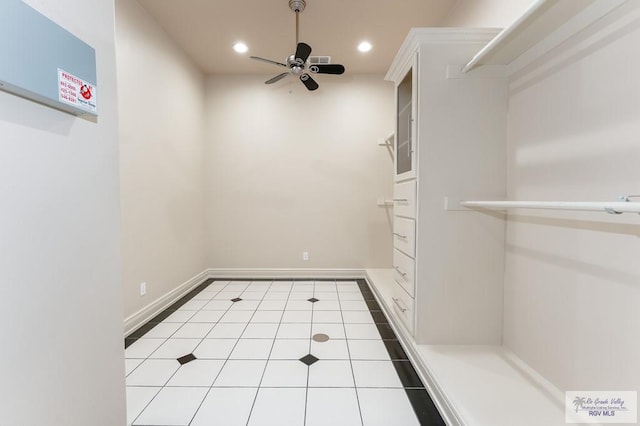 interior space with light tile patterned floors and ceiling fan