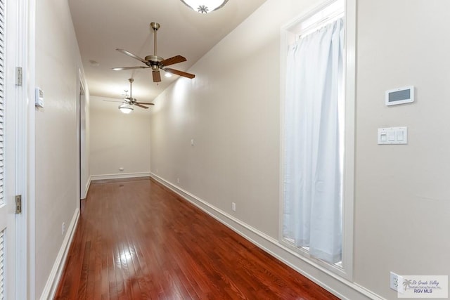 empty room with ceiling fan and wood-type flooring