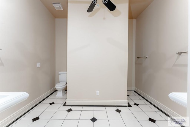 bathroom with toilet and ceiling fan