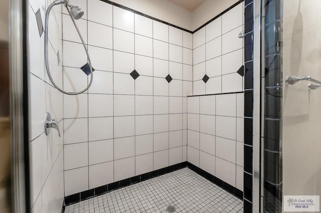 bathroom with tiled shower