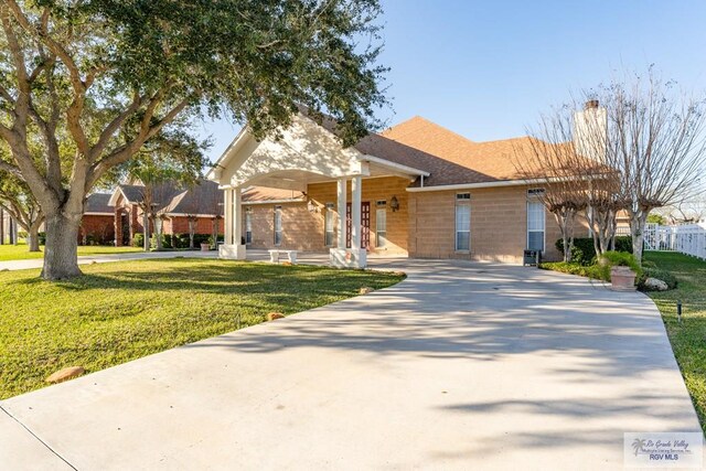 405 E Matz Ave, Harlingen, TX 78550 - single story home featuring concrete driveway, a front yard, a chimney, and a shingled roof