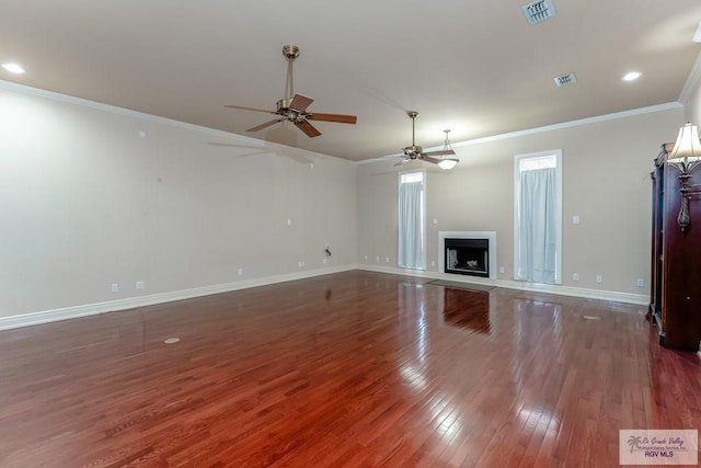 405 E Matz Ave, Harlingen, TX 78550 - unfurnished living room with ceiling fan, ornamental molding, wood finished floors, baseboards, and a fireplace