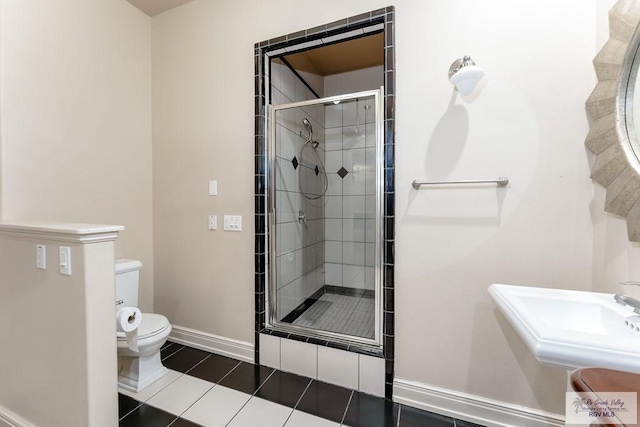 bathroom featuring walk in shower, tile patterned floors, sink, and toilet