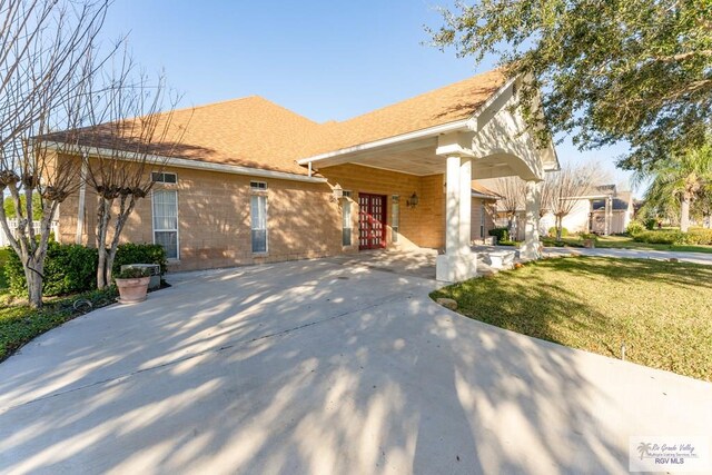 405 E Matz Ave, Harlingen, TX 78550 - ranch-style house with a front lawn and french doors
