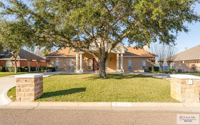 405 E Matz Ave, Harlingen, TX 78550 - view of front of home with a front lawn and covered porch