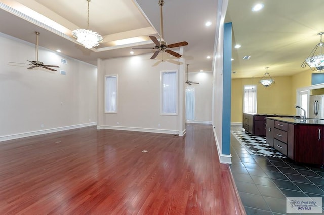 unfurnished living room featuring a chandelier and dark hardwood / wood-style floors