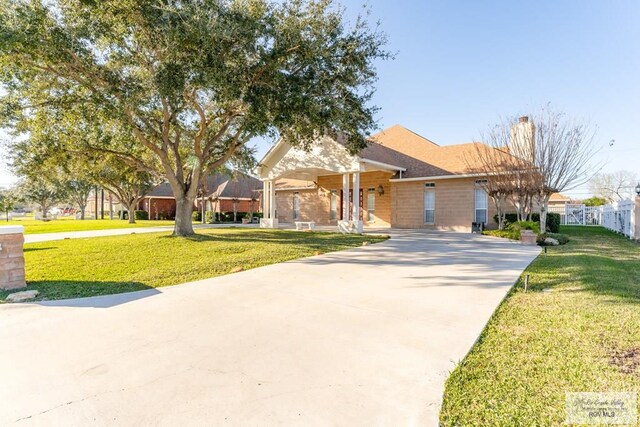 405 E Matz Ave, Harlingen, TX 78550 - view of front of house featuring concrete driveway, covered porch, and brick siding