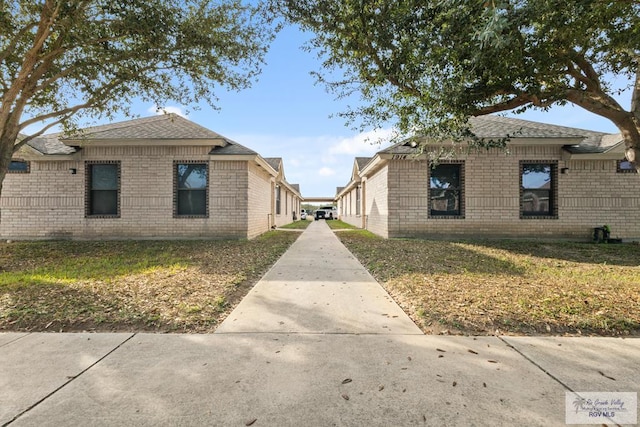 view of side of home featuring a lawn