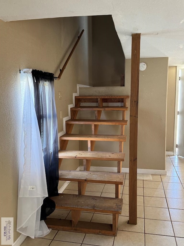 stairs featuring tile patterned flooring