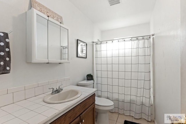 full bathroom with tile patterned floors, vanity, toilet, and shower / bathtub combination with curtain