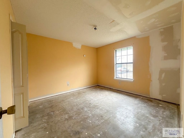 spare room with a textured ceiling