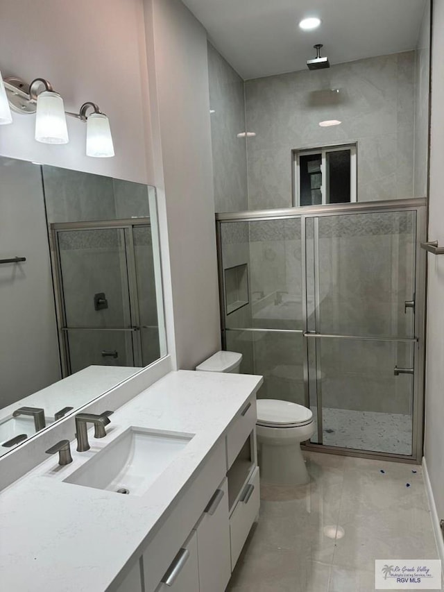 full bathroom featuring vanity, marble finish floor, toilet, and a shower stall