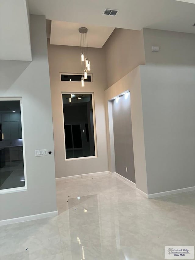 foyer entrance with visible vents and baseboards