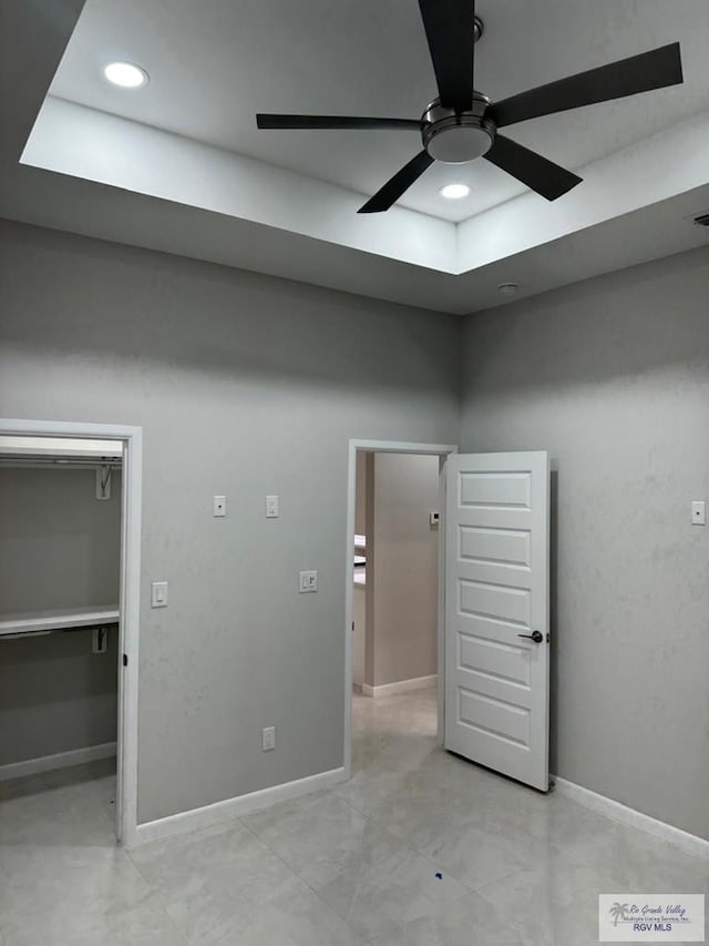 unfurnished bedroom with ceiling fan, a walk in closet, recessed lighting, baseboards, and visible vents