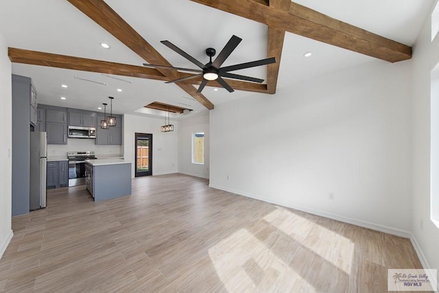 unfurnished living room featuring ceiling fan with notable chandelier, lofted ceiling with beams, and light hardwood / wood-style flooring