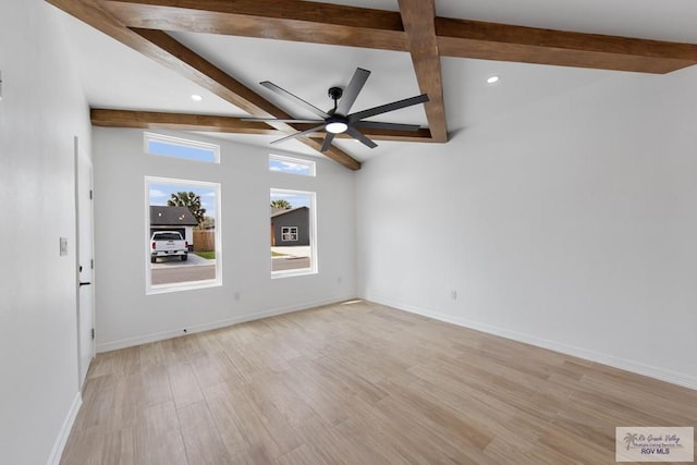 empty room featuring vaulted ceiling with beams, ceiling fan, and light hardwood / wood-style floors