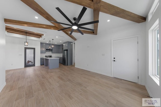 unfurnished living room featuring ceiling fan, light hardwood / wood-style floors, and lofted ceiling with beams