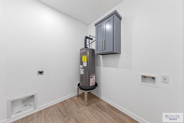 washroom featuring cabinets, washer hookup, light wood-type flooring, electric dryer hookup, and water heater