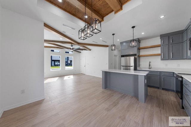 kitchen with gray cabinetry, ceiling fan, hanging light fixtures, and appliances with stainless steel finishes