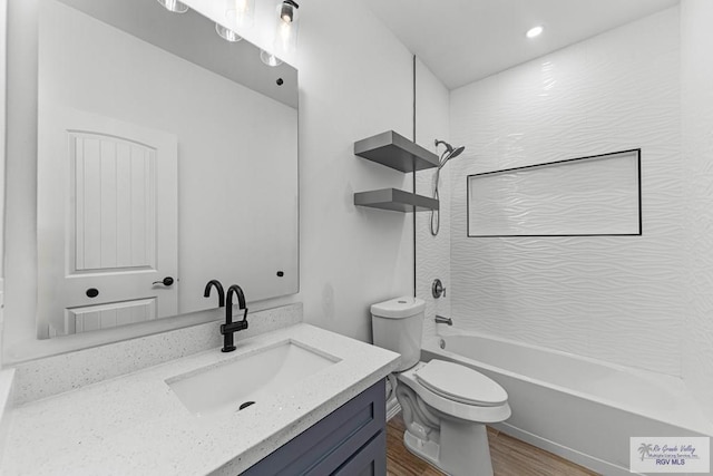 full bathroom featuring vanity, wood-type flooring,  shower combination, and toilet