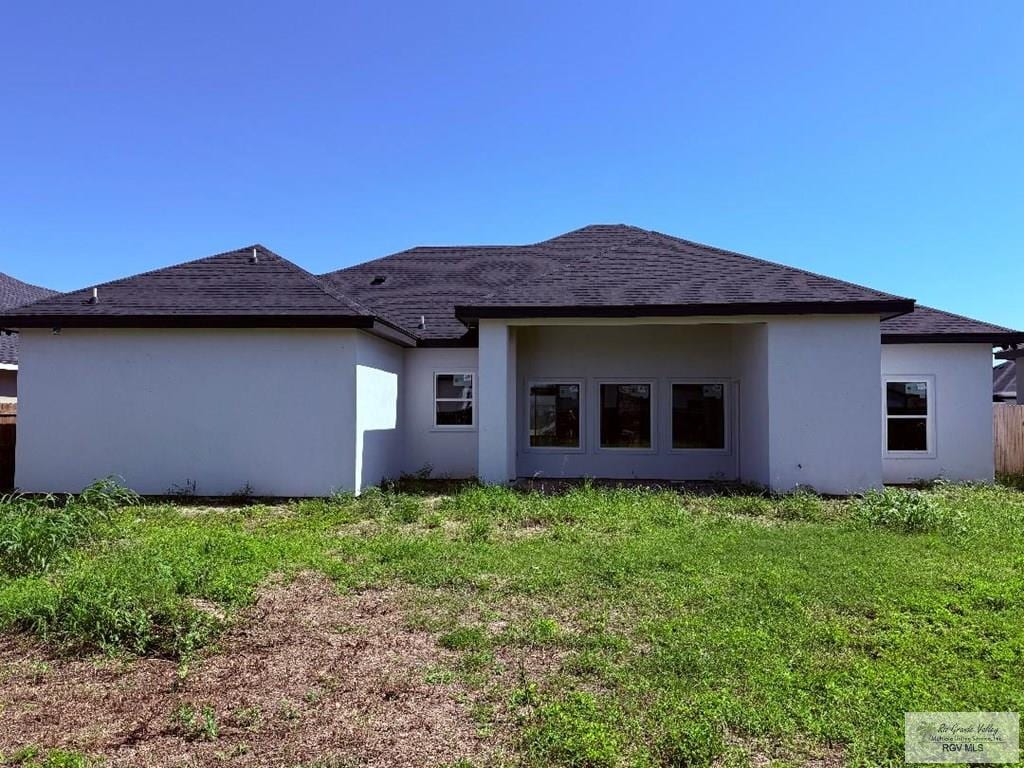 9608 Lake Concordia Ct, Los Fresnos, TX 78566 - rear view of house with stucco siding and a lawn