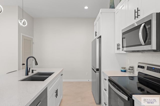213B W Cora Lee Dr Unit B, South Padre Island, TX 78597 - kitchen featuring appliances with stainless steel finishes, white cabinets, recessed lighting, hanging light fixtures, and light stone counters