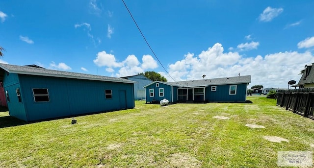 back of house featuring a yard