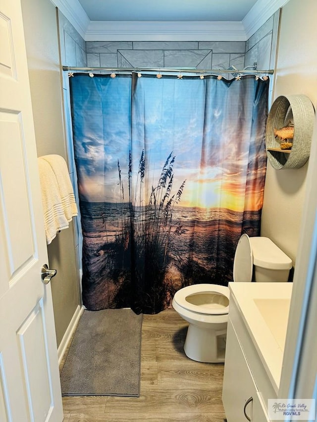 bathroom with walk in shower, vanity, crown molding, hardwood / wood-style flooring, and toilet