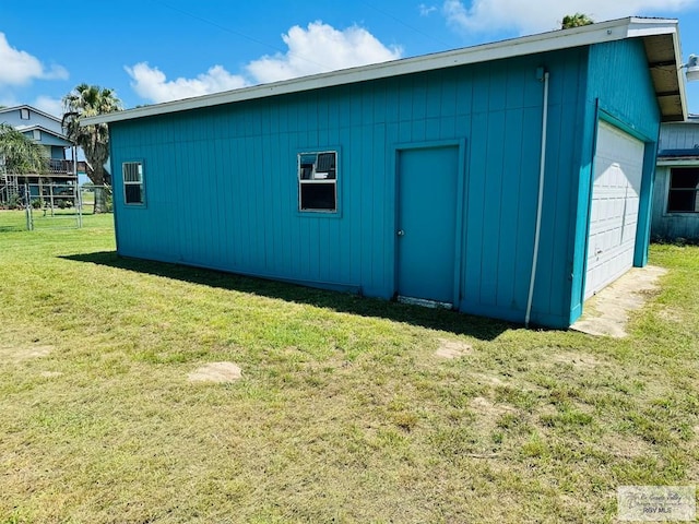 view of outbuilding featuring a yard and a garage