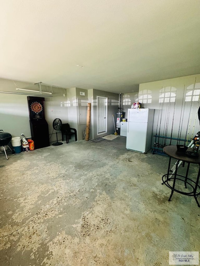 garage featuring white fridge and gas water heater