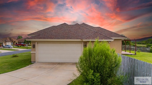 view of front facade with a lawn and a garage