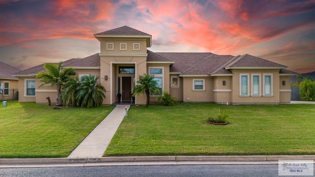 view of front of property with a lawn