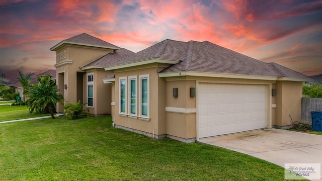 view of front of home featuring a garage and a yard